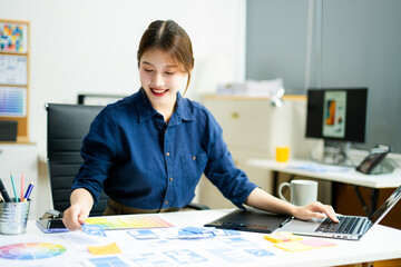 designer holds wireframe cards while planning UX/UI in a creative office, showcasing innovation,...