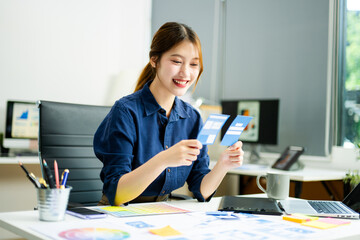 designer holds wireframe cards while planning UX/UI in a creative office, showcasing innovation,...