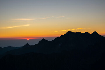 Obraz premium Mountain peaks at sunrise. Sunlight falling, painting with light, Rysy in the Polish Tatra Mountains