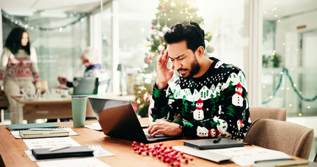Headache, Christmas and man in office with laptop for stress, burnout or fatigue for workload....