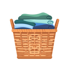 Brown woven wicker laundry basket with handles, filled with a stack of folded blue and green clothes.