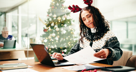 Christmas, business and woman with documents, laptop and deadline for budget report. Xmas, person...