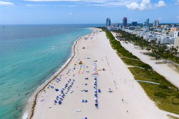 Drone aerial view of Miami sandy beach. Wide drone shot of Miami Beach and ocean waves. Miami...