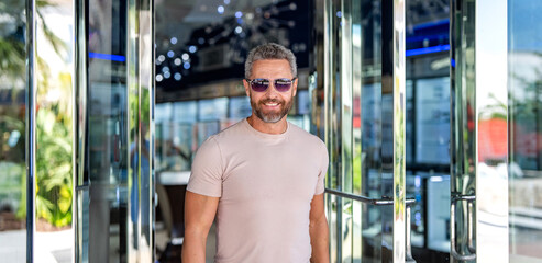 Stylish handsome man with graying hair. Stylish male. Male casual style. Portrait mature man in...