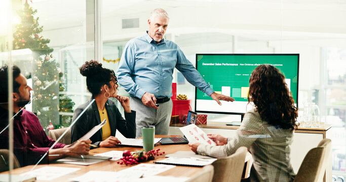 Computer screen, presentation and review with business people at work for December sales performance. Christmas, infographic and meeting with employee team in boardroom for chart or graph discussion