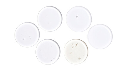 Six clear round liquid-filled petri dishes arranged with one slightly different in color, showing small air bubbles inside.