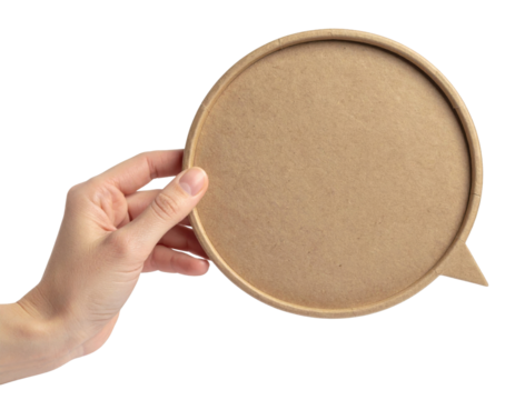 A hand holding a round, brown cardboard speech bubble with a small triangular pointer on the side.