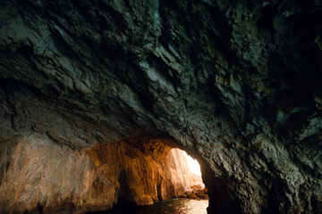 Dimly Lit Cave with Sunlit Opening