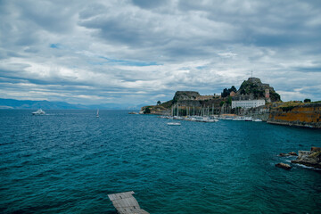 Coastal Fortress with Yachts and Cloudy Sky