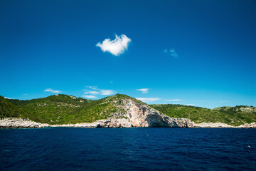 Scenic Rocky Coastline with Lush Green Hills
