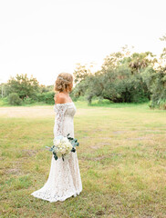 Bride in Lace Wedding Dress Holding Bouquet Negative Space Right