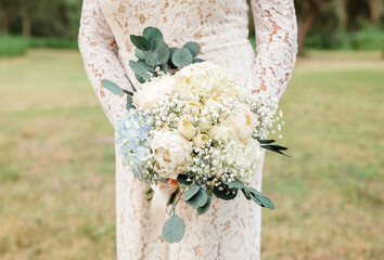 Bride Holding Elegant White Floral Bouquet in Punta Gorda, Flori