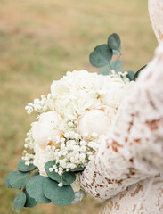 Bride Holding Elegant White Floral Bouquet in Punta Gorda, Flori