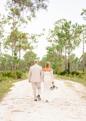 Bride and Groom Walking Down Scenic Path in Punta Gorda, Florida