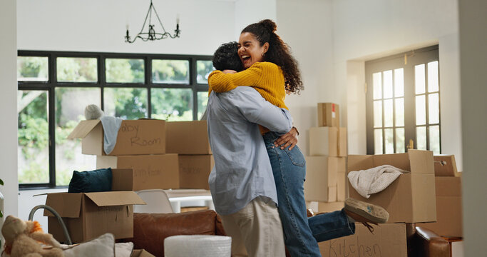 Hug, success and moving with couple in new home for property, support and mortgage approval. Real estate investment, celebration and relocation with man and woman in living room for house purchase