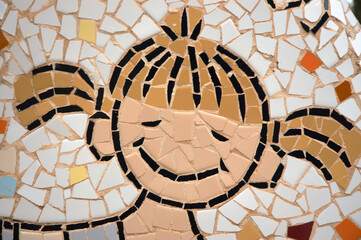 drawings of children's faces made up of small pieces of tile