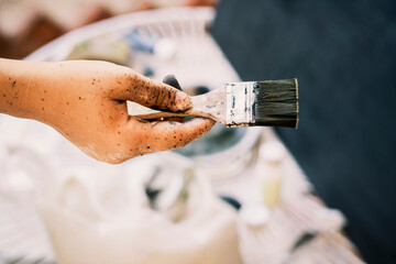 Close-up of a Hand Holding a Paintbrush Covered in Paint - Artistic Process