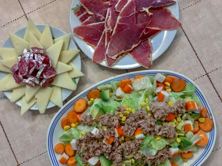 dishes with ham, cheese, fuet and assorted salad