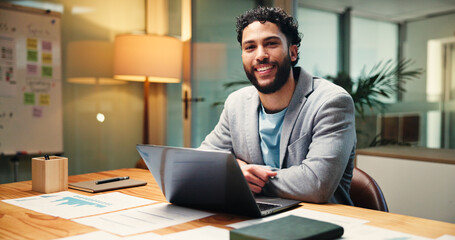 Laptop, portrait and smile of business man in office at night for social media statistics....