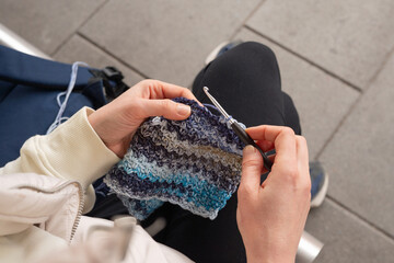 Caucasian adult female crocheting multicolored yarn with silver hook I Love Yarn Day