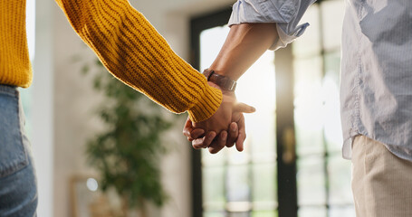 Love, holding hands and care with couple in house for romantic connection, support and trust....