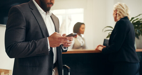 Businessman, hotel and waiting with phone for check in, accommodation or online booking in resort....