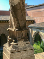 carved stone pillar with defocused palace in the background