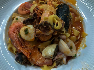 typical dish of italian cuisine, tagliatelle with seafood