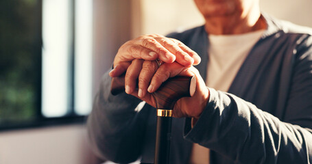 Senior hands, walking stick and recovery in home for injury, stroke or osteoporosis in retirement....