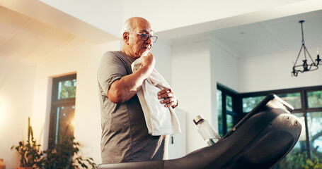 Treadmill, senior man and towel for exercise break, tired and training recovery in home. Cardio...