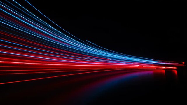 Abstract depiction of vibrant red and blue light trails streaking through darkness, symbolizing speed and data flow