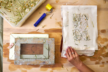 Top view of handmade floral paper on cloth, ready for drying. Final stage of eco-friendly DIY...