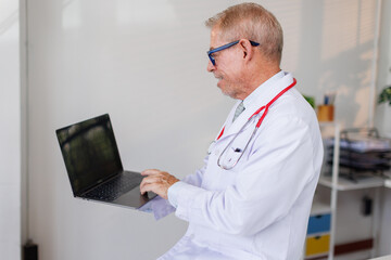 healthcare, Mala doctor character holds laptop and standing in workplace.Professional consultation....