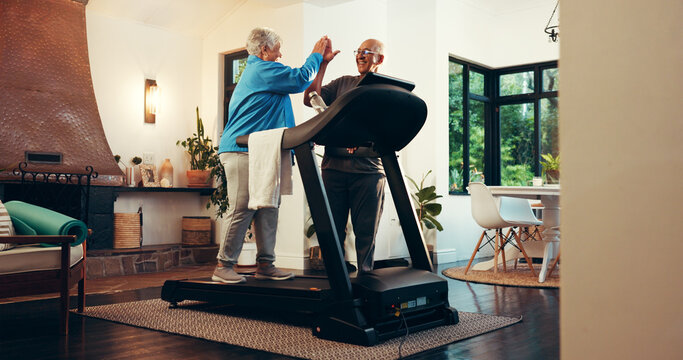 Senior couple, treadmill and high five for fitness in home, walk and support with training in retirement. Elderly man, woman and motivation with gym equipment, machine or steps with exercise in house