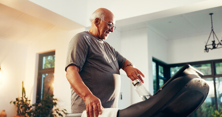 Treadmill, water and watch with senior man in living room of home for exercise or fitness. Time, training and workout with old person walking on machine in apartment for cardio, challenge or progress