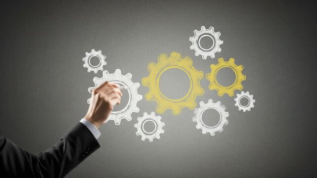 Businessman drawing interconnected gears illustrating teamwork and business strategy.