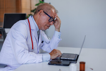 Portrait of sad male doctor upset tired medical worker closing head with hands. Depressed male...