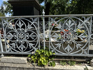 Ornate metal fence of a tombstone
