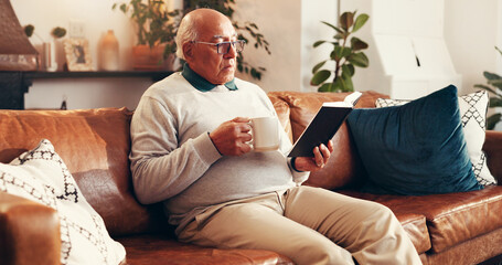 Coffee, reading and senior man with bible in home for worship, faith and spiritual wellness. Relax,...