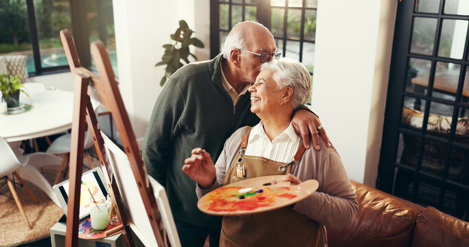 Senior couple, kiss and painting on canvas for art, drawing sketch and bonding together. Above, elderly people and love of partner with craft artwork, creation and talent for retirement hobby in home - Powered by Adobe