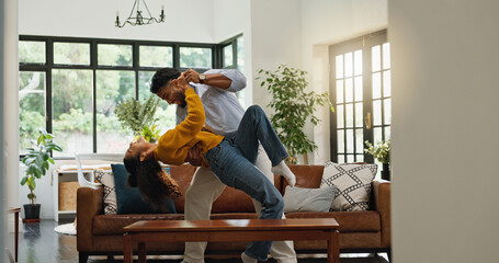 Home, dancing and couple in lounge, love and bonding together with romance, smile and relationship. Apartment, movement and man with woman, marriage and happiness with music, energy and celebration