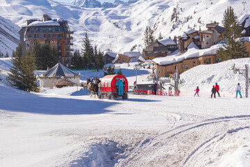 Horse drawn sleigh transporting guests through the car free resort of Avoriaz in the French Alps