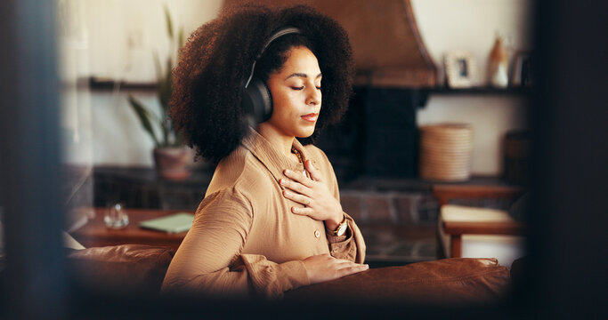 Meditation, relax and woman with headphones in home for calm, peace and zen. Music, mindfulness audio and African person listening to podcast, streaming radio or breathe for self care in living room