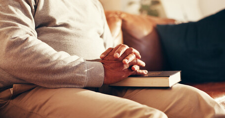 Faith, hands and bible with old man on sofa for worship, gratitude and peace. Praying, spiritual...
