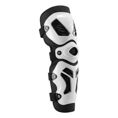 A single new pristine black and white motocross knee and shin guard with silver metal hinges, soft foam padding, and elastic straps, centered on a seamless stark white studio background with diffused