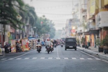 City Street with Motorbikes and Vehicles on a Busy Morning