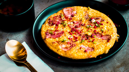 Gourmet Breakfast Scene: Eggs, Meaty Goodness, and Zesty Condiment.