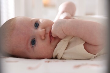Cute newborn baby lying in crib, closeup