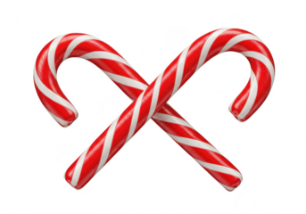 Two red and white striped candy canes are crossed in a festive holiday display isolated on transparent background