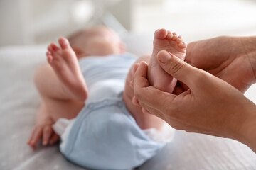 Pediatrician examining baby at table in clinic, closeup